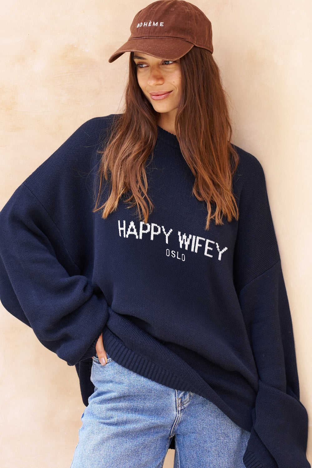 The oversized knitted sweater in Coastal Blue, styled on the model
