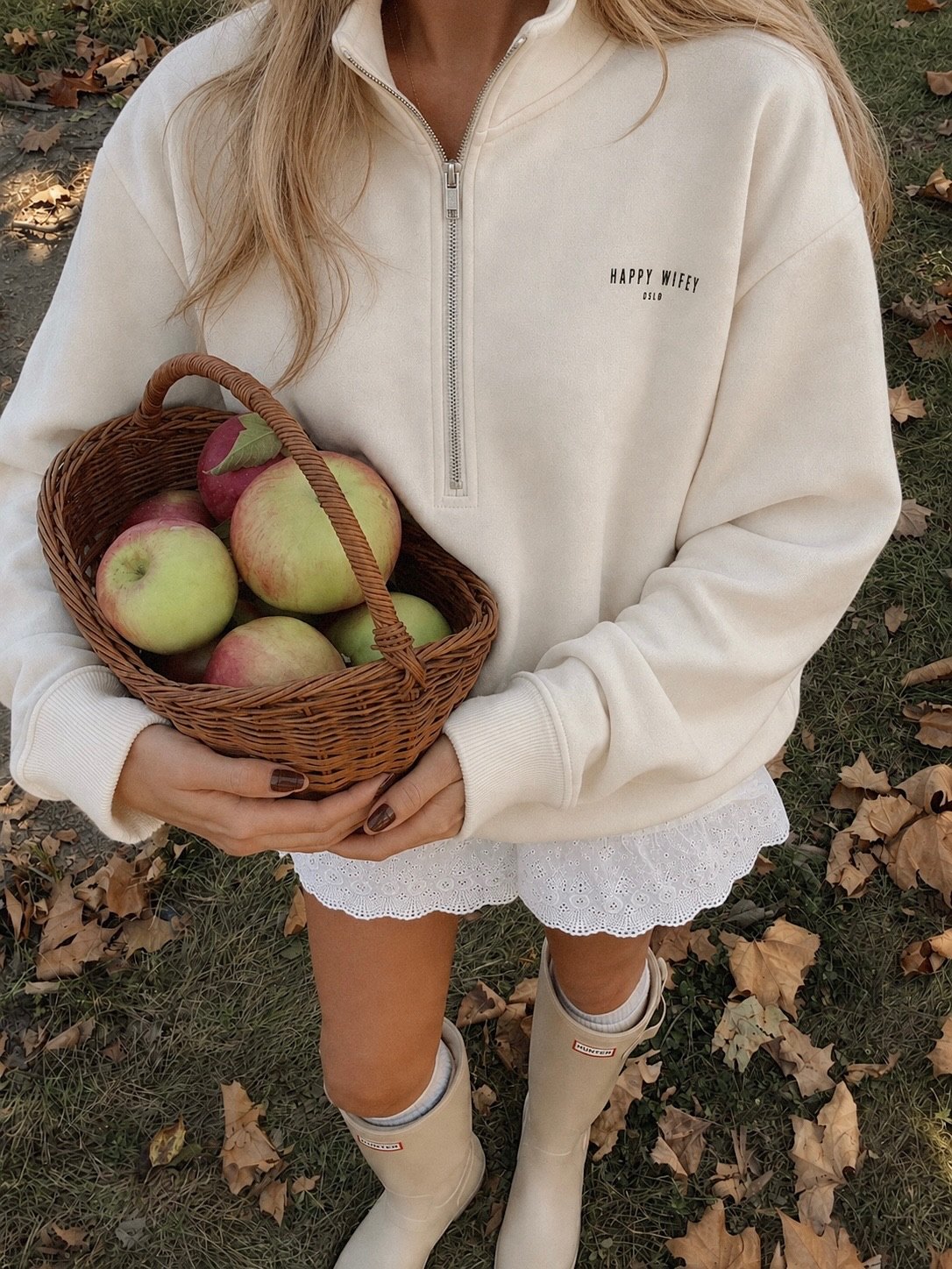 Apple picking in a cream Happy Wifey zip sweatshirt
